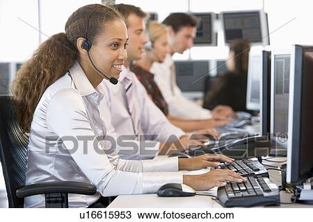 Stock Image - Stock Traders Working At Computers. Fotosearch