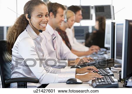 Stock Image - Stock Traders Working At Computers. Fotosearch