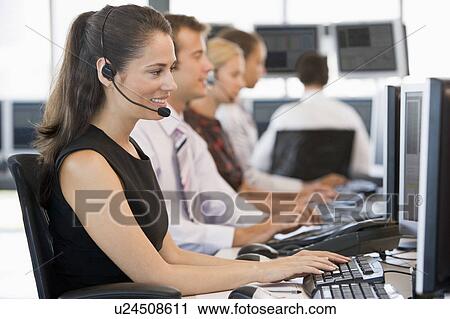 Stock Image - Stock Traders Working At Computers. Fotosearch