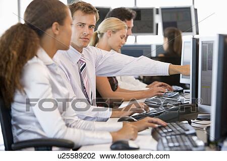 Stock Image - Stock Traders Working At Computers. Fotosearch