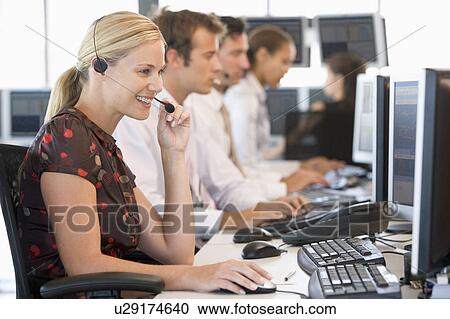 Stock Image - Stock Traders Working At Computers. Fotosearch