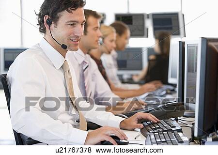 Stock Photo - Stock Traders Working At Computers. Fotosearch