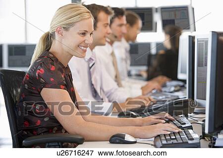 Stock Photo - Stock Traders Working At Computers. Fotosearch