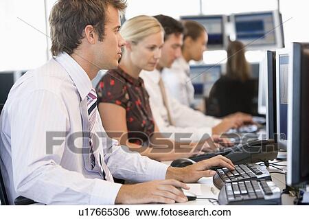 Stock Photograph - Stock Traders Working At Computers. Fotosearch