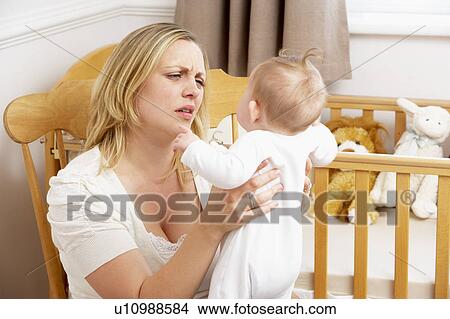 Stressed Mother Holding Baby In Nursery View Large Photo Image Picture - Stressed Mother Holding Baby In Nursery. Fotosearch