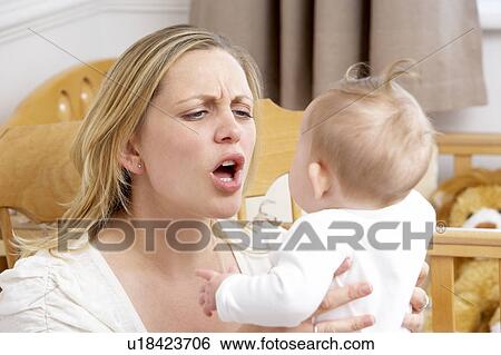 Stressed Mother Holding Baby In Nursery View Large Photo Image Stock Photograph - Stressed Mother Holding Baby In Nursery. Fotosearch