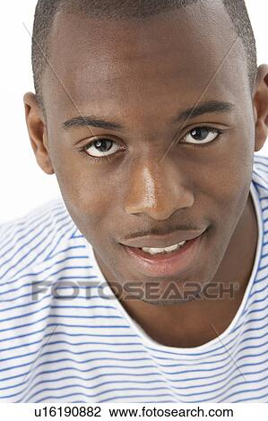 Stock Image - Studio Portrait Of Smiling Teenage Boy. Fotosearch