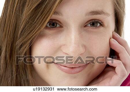 Stock Image - Studio Portrait Of Smiling Teenage Girl. Fotosearch