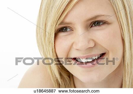 Stock Photo - Studio Portrait Of Smiling Teenage Girl. Fotosearch