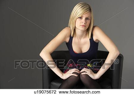 Studio Portrait Of Teenage Girl Sitting In Chair View Large Photo Image Stock Image - Studio Portrait Of Teenage Girl Sitting In Chair. Fotosearch