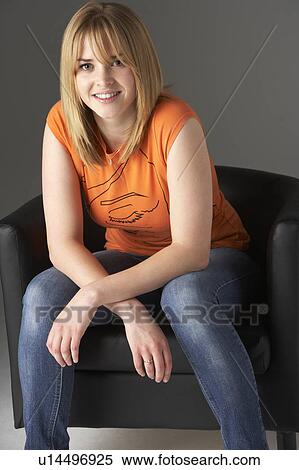 Stock Photography - Studio Portrait Of Teenage Girl Sitting In Chair. Fotosearch