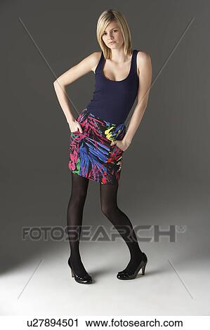 Stock Image - Studio Portrait Of Teenage Girl Standing In Studio. Fotosearch