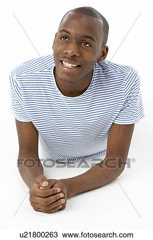 Stock Image - Teenage Boy Laying On Stomach. Fotosearch