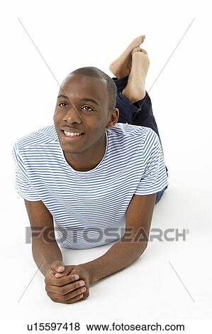 Stock Photo - Teenage Boy Laying On Stomach. Fotosearch