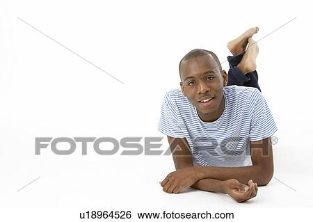 Teenage Boy Laying On Stomach View Large Photo Image Stock Photograph - Teenage Boy Laying On Stomach. Fotosearch