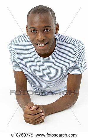 Teenage Boy Laying On Stomach View Large Photo Image Stock Photography - Teenage Boy Laying On Stomach. Fotosearch
