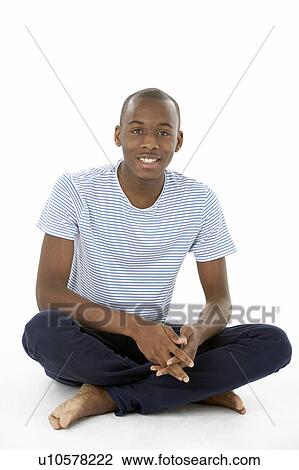 Stock Image - Teenage Boy Sitting In Studio. Fotosearch