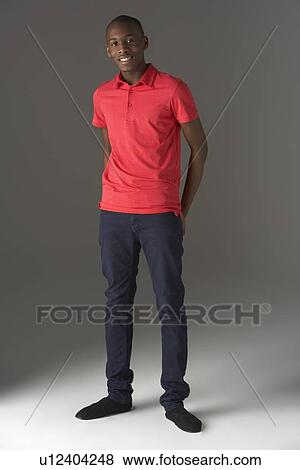 Stock Photo - Teenage Boy Standing In Studio. Fotosearch