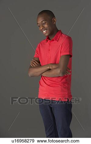 Stock Photo - Teenage Boy Standing In Studio. Fotosearch