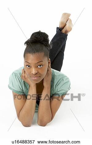 Stock Photo - Teenage Girl Laying On Stomach. Fotosearch
