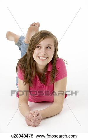 Stock Photo - Teenage Girl Laying On Stomach. Fotosearch