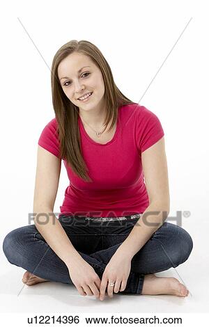 Stock Photograph - Teenage Girl Sitting In Studio. Fotosearch