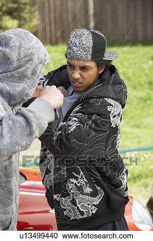 Stock Image - Two Young Men Fighting. Fotosearch
