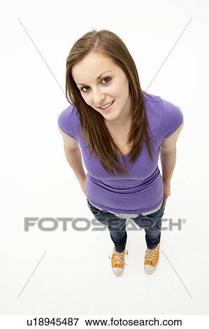 Stock Photo - Young Girl Standing In Studio. Fotosearch