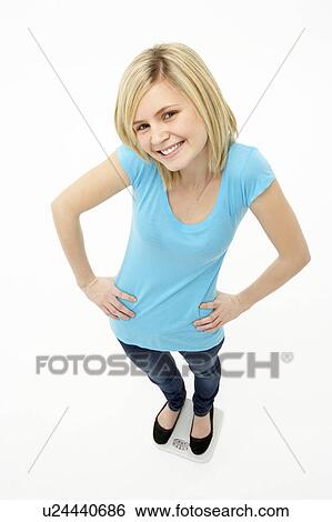 Stock Photograph - Young Girl Standing In Studio. Fotosearch