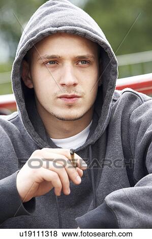 Young Man Sitting In Playground Smoking Joint View Large Photo Image Stock Photo - Young Man Sitting In Playground Smoking Joint. Fotosearch