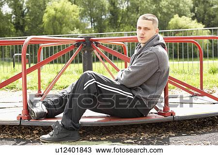 Young Man Sitting In Playground View Large Photo Image Stock Image - Young Man Sitting In Playground. Fotosearch