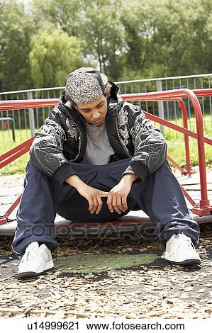 Young Man Sitting In Playground View Large Photo Image Stock Image - Young Man Sitting In Playground. Fotosearch