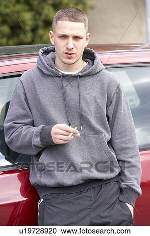 Young Man Standing Next To Car View Large Photo Image Stock Image - Young Man Standing Next To Car. Fotosearch