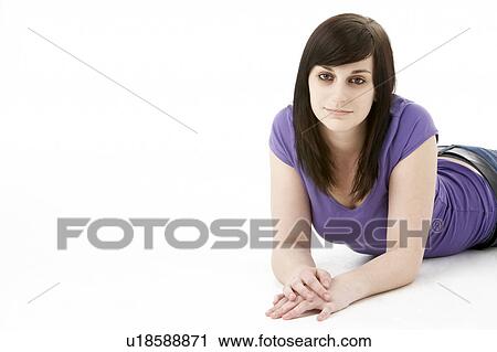 Stock Image - Young Woman Laying On Stomach. Fotosearch