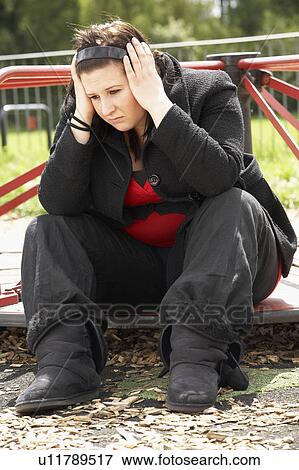 Stock Photo - Young Woman Sitting In Playground. Fotosearch