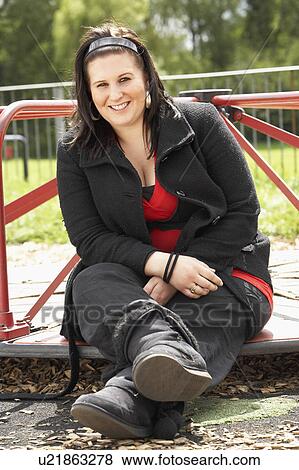 Young Woman Sitting In Playground View Large Photo Image Stock Photo - Young Woman Sitting In Playground. Fotosearch