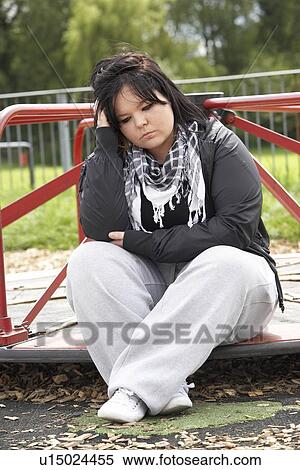 Stock Photography - Young Woman Sitting In Playground. Fotosearch