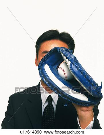 Stock Image - Businessman grabbing a baseball with glove, Close Up. Fotosearch