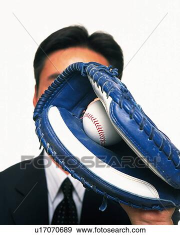 Businessman grabbing a baseball with glove, Close Up View Large Photo Image Stock Photo - Businessman grabbing a baseball with glove, Close Up. Fotosearch