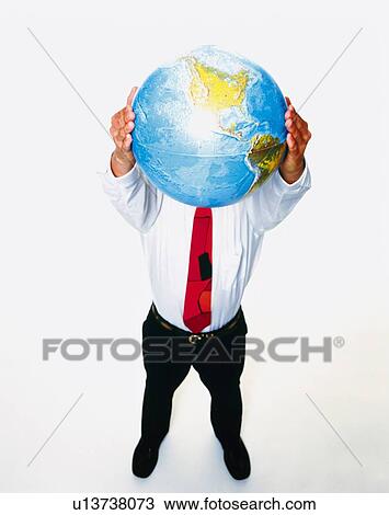 Stock Image - Businessman holding and raising a globe with both hands, High Angle View. Fotosearch