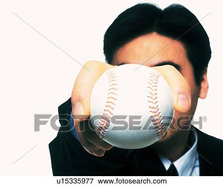 Stock Photo - Businessman holding and raising a baseball, High Angle View, Close Up. Fotosearch