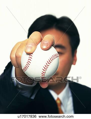 Stock Photograph - Businessman holding and raising a baseball, High Angle View. Fotosearch
