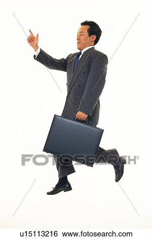 Businessman jumping with pointing finger, Side View View Large Photo Image Stock Photograph - Businessman jumping with pointing finger, Side View. Fotosearch
