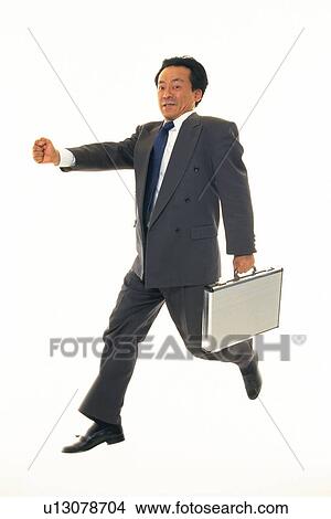 Businessman jumping with stretched fist, Side View View Large Photo Image Picture - Businessman jumping with stretched fist, Side View. Fotosearch