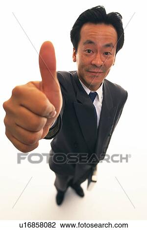 Stock Image - Businessman putting thumb up in the air with smile, High Angle View. Fotosearch