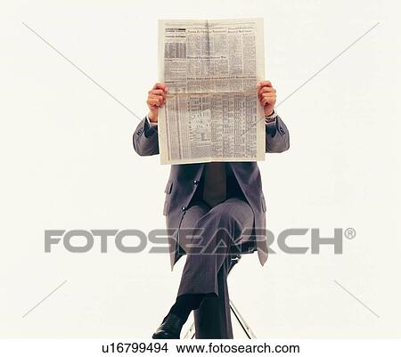 Picture - Businessman reading news paper, Front View. Fotosearch