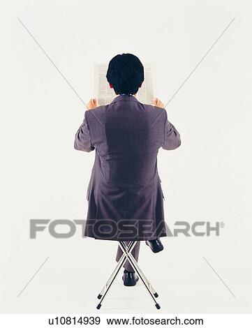 Businessman reading news paper, Rear View View Large Photo Image Stock Photo - Businessman reading news paper, Rear View. Fotosearch