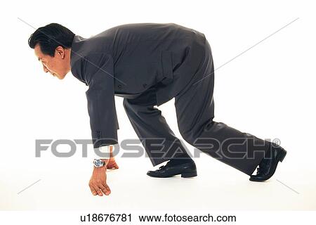 Stock Image - Businessman with crouching start pose, Side View. Fotosearch
