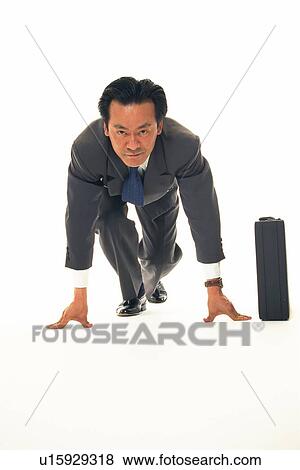 Stock Photo - Businessman with crouching start pose, Front View. Fotosearch