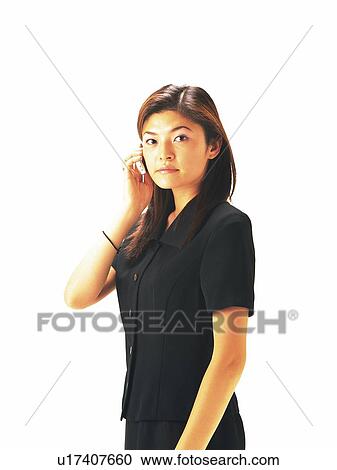 Businesswoman looking at camera and using mobile phone, Side View View Large Photo Image Stock Image - Businesswoman looking at camera and using mobile phone, Side View. Fotosearch